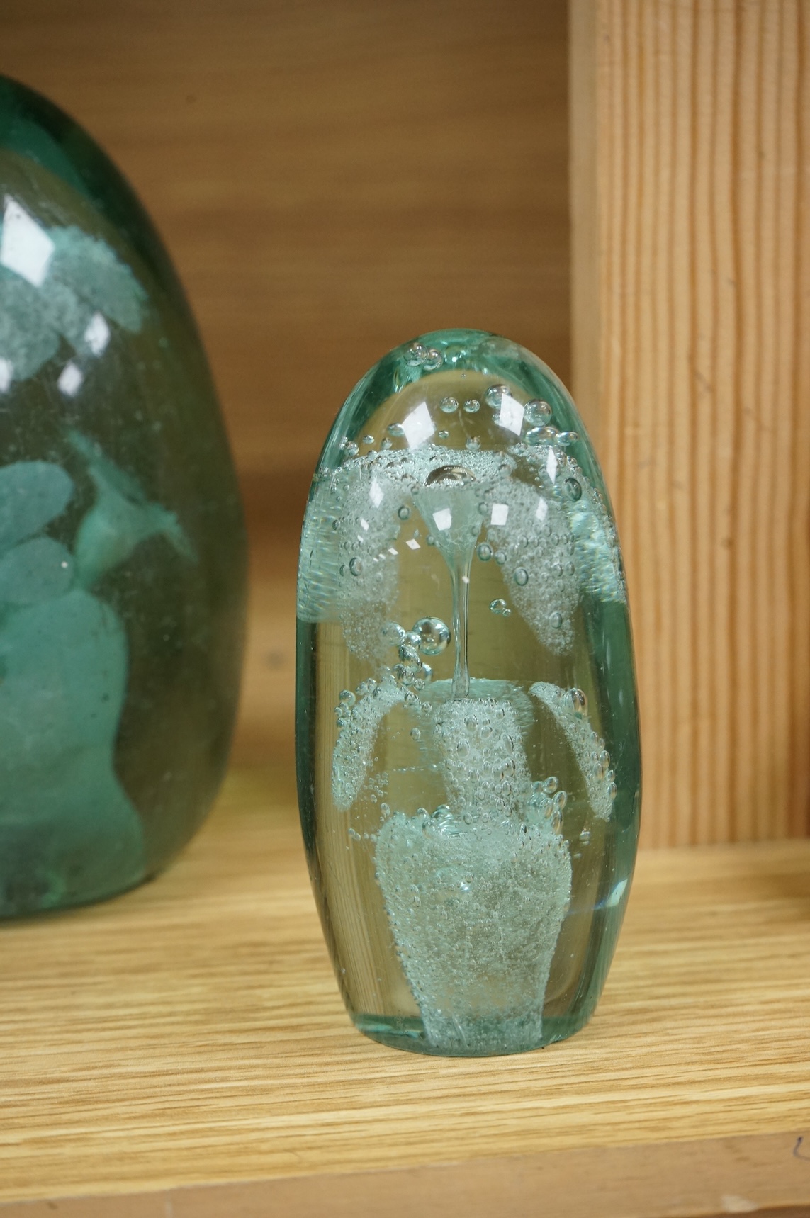 Three Victorian green glass dump weights, largest 14cm high